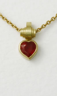 Ruby Heart necklace on yellow gold trace chain